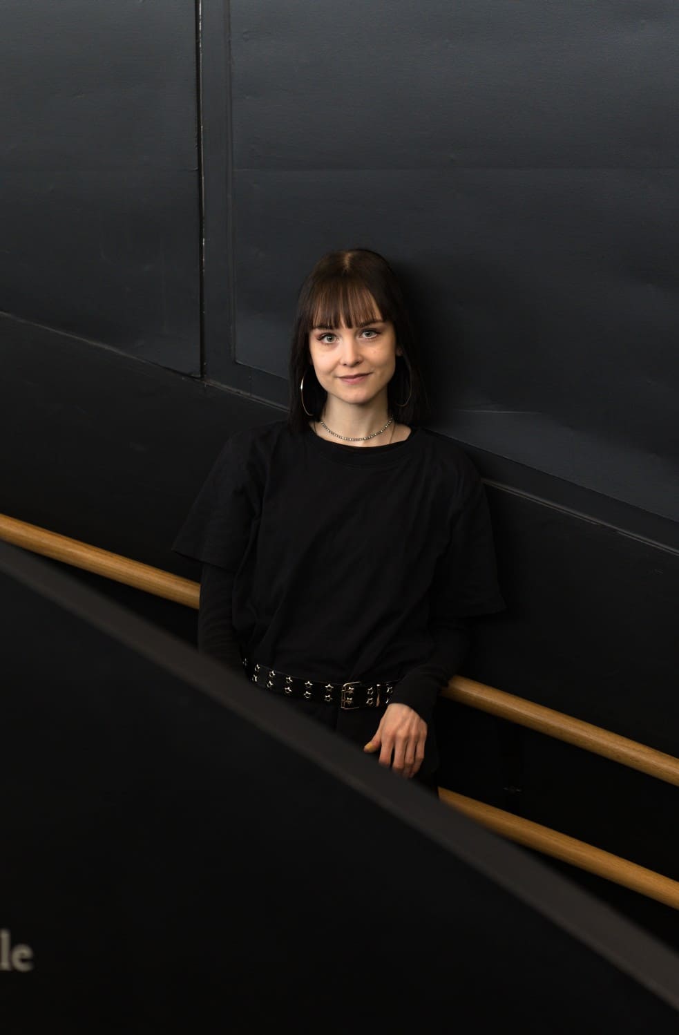 woman in front of a black wall