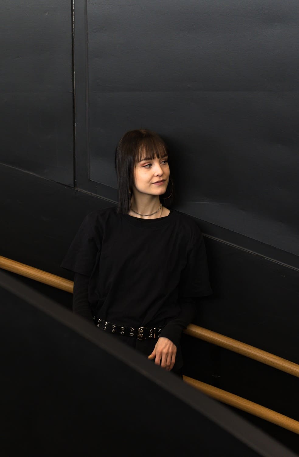 woman in front of a black wall